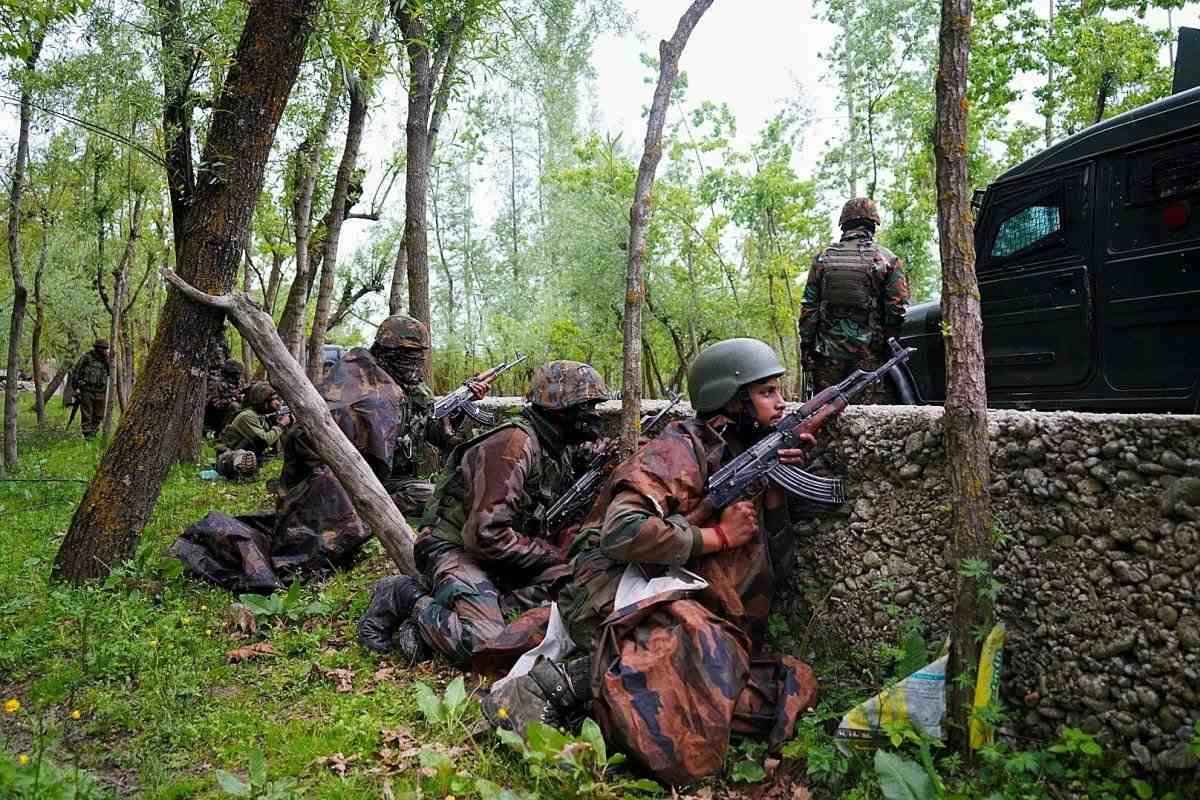 Army Kupwara: Security personnel take position during a cordon and search operation after an encounter between holed up terrorists and the security forces in the Chanjimulla village of Handwara tehsil in Jammu and Kashmir's Kupwara district on May 3, 2020. Seven including two senior Army officers, two junior ranks, an officer of the local police and two terrorists were killed in the fierce gunbattle on Sunday. Two terrorists have also been killed in this encounter whose exact identity is being established. Although firing has stopped at the encounter site, but searches are going on there. (Photo: IANS)