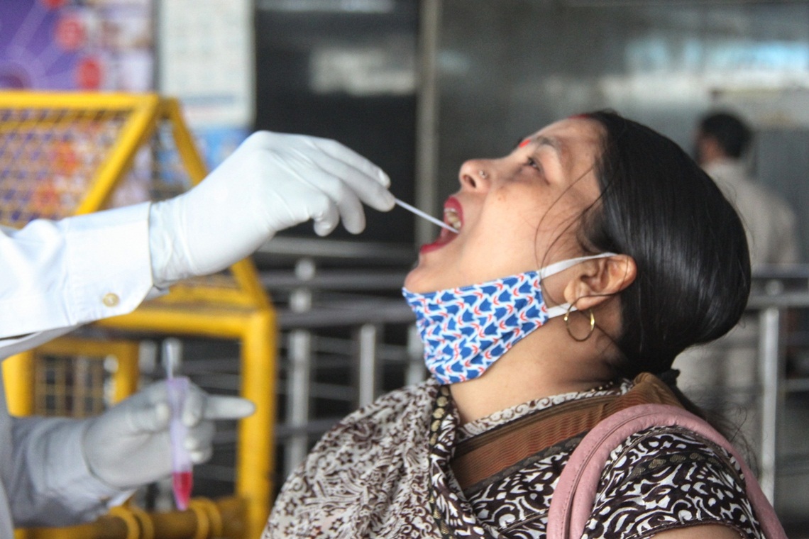 New Delhi: Health worker collect swab sample for Covid-19 testing at New Delhi railway station in New Delhi on Thursday, 20 May, 2021(Photo: Wasim Sarvar/IANS)